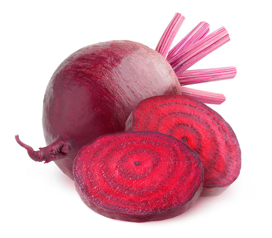 A whole beet next two a coupe of slices of beet