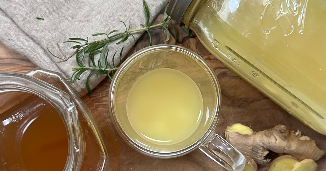 Ginger shots and syrup on a wooden cutting board