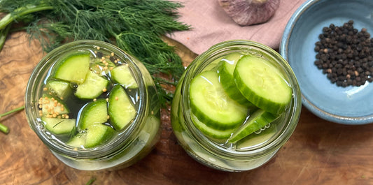 Jars of pickles on a cutting board