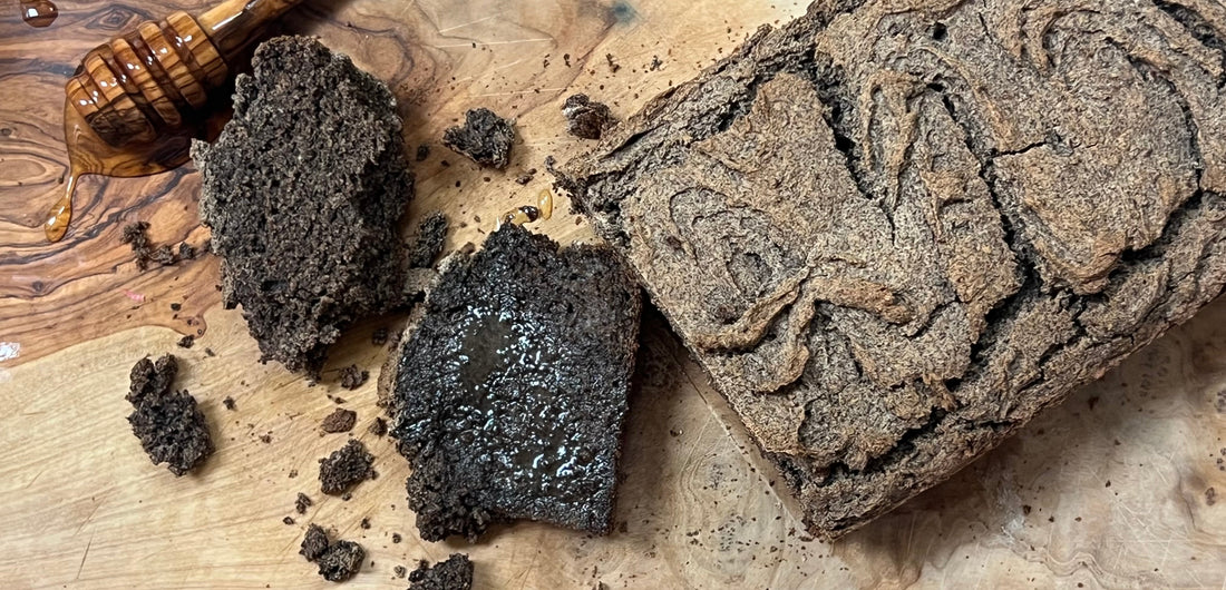 Slices of buckwheat bread ona cutting board with butter and honey 