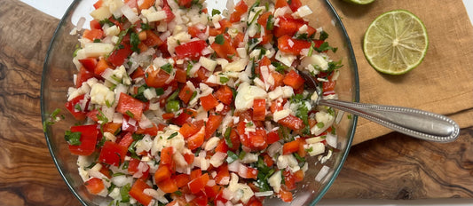 Hearts of Palm Ceviche in a glass bowl with a lime off to the side 