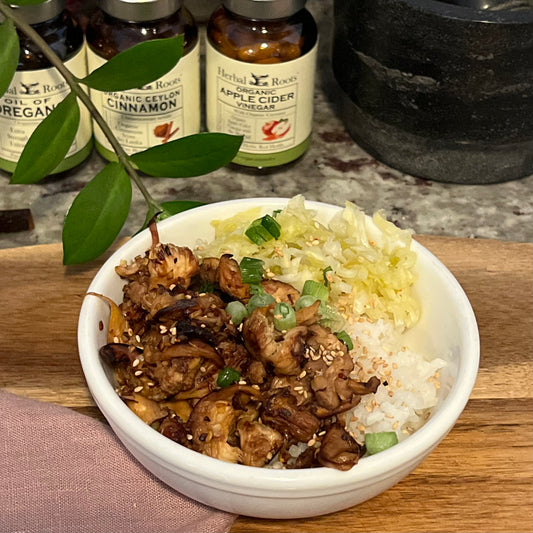 Completed lions mane dish served over rice with picked veggies