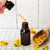 
                  Flowers of St Johns wort near a small bottle with dropper full of st johns wort oil
                