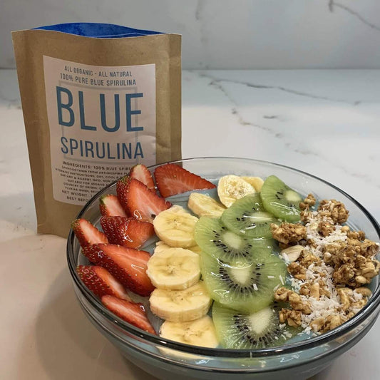 Blue Spirulina powder package with spirulina and fruit smoothie bowl