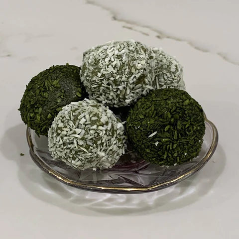 
                  5 matcha energy balls stacked on a small glass plate
                