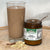 
                  Glass of smoothie next to jar of Irish moss with rolled oats pile in front of glass
                