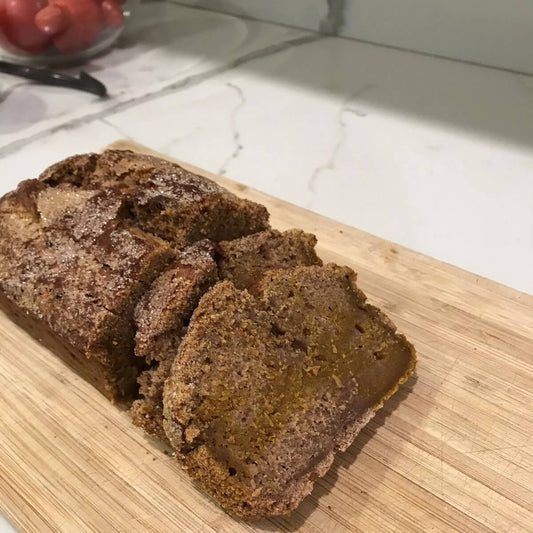 Cut loaf of banana/pumpkin bread on a cutting board