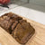 
                  Cut loaf of banana/pumpkin bread on a cutting board
                